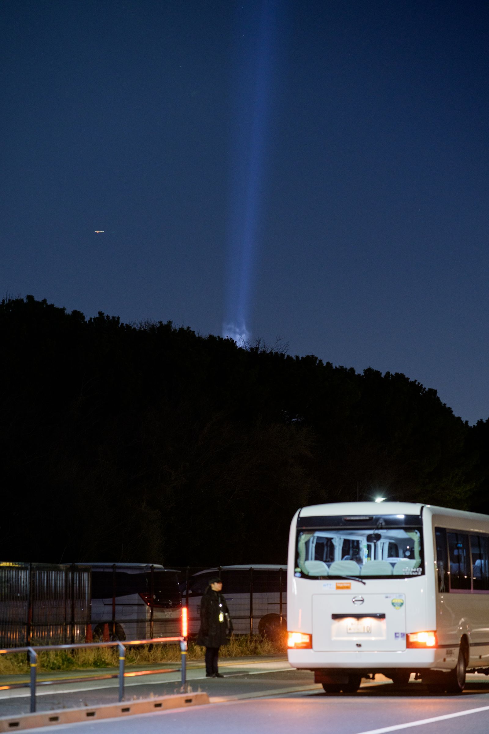 Parallel Forests — shuttle bus with light beam over the forest